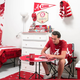 Illustration for article titled We Challenged Two Guys To Decorate A Dorm Room Using Only Fan Merch